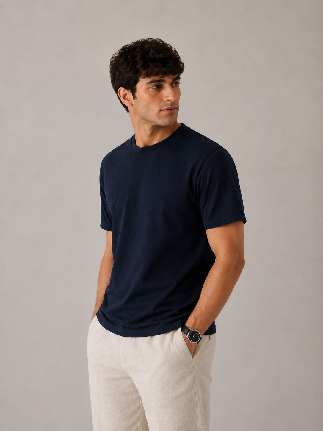 Men's navy blue crew neck t-shirt, side angle view showing relaxed-tailored drape