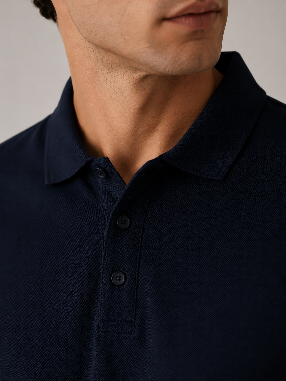 Men’s midnight navy polo shirt, flat lay front view, architectural ribbed spread collar