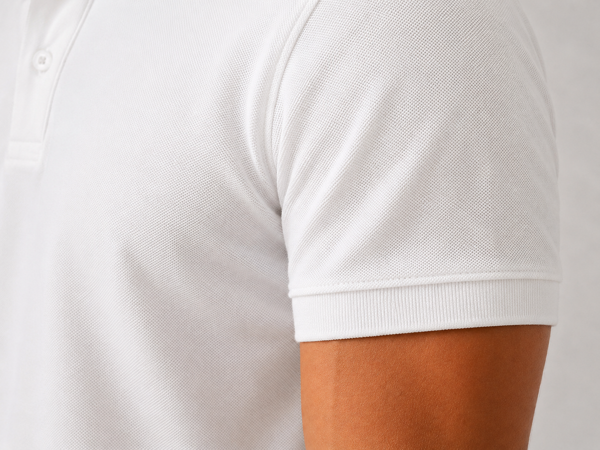 Men’s heavyweight white polo shirt, angled detail view, fine 220 GSM Airtex fabric texture