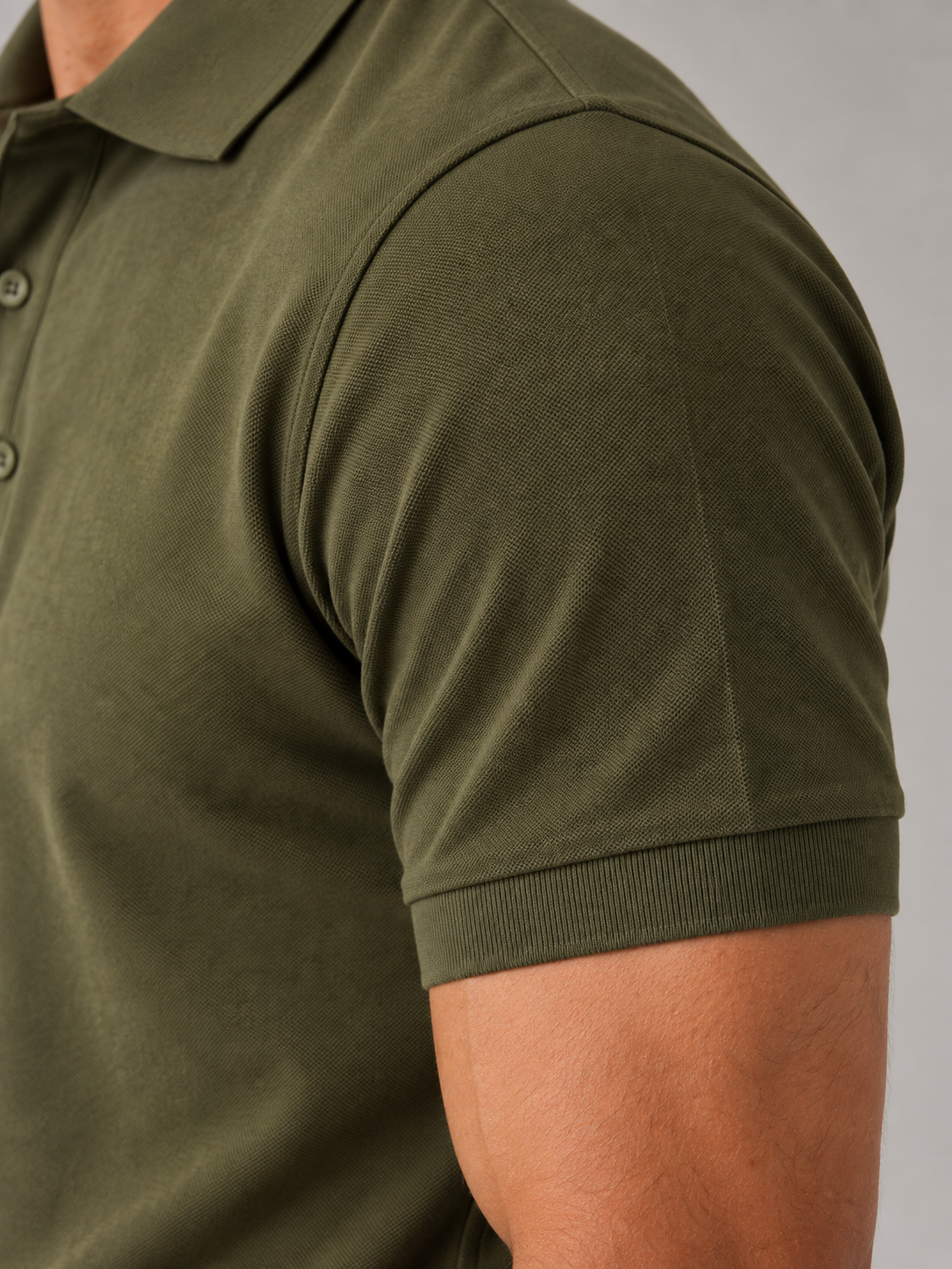 Men's olive green Cotton Airtex polo shirt, macro fabric texture detail showing honeycomb knit