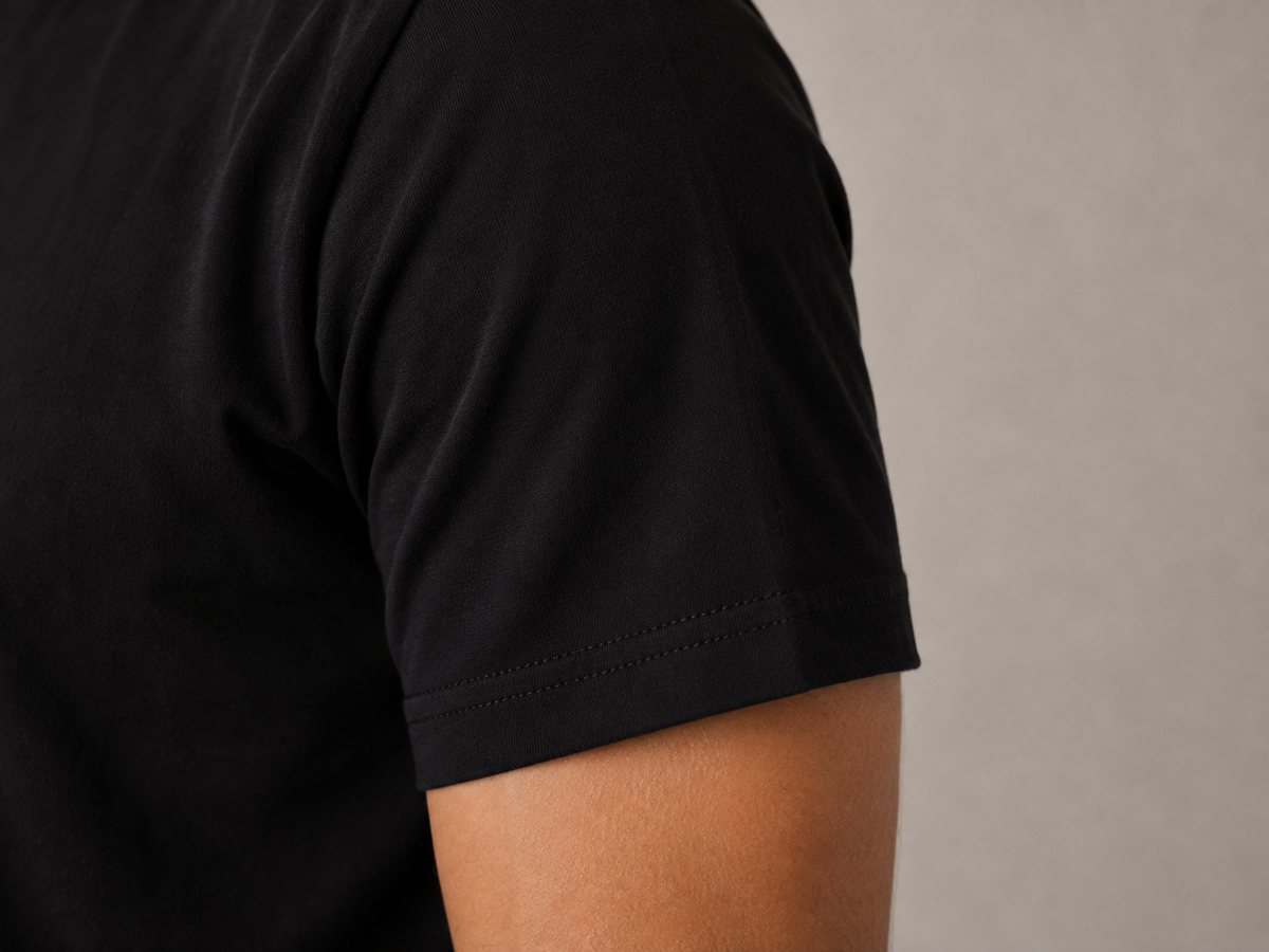 Men's black crew neck t-shirt, sleeve hem and 240 GSM Supima cotton jersey texture detail