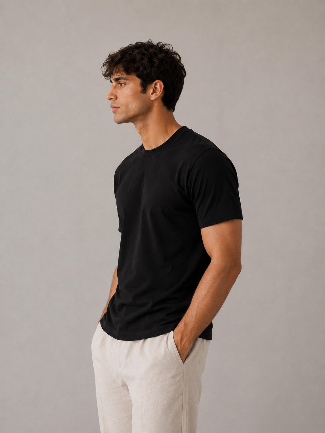 Men's black crew neck t-shirt, side profile view showing tailored drape and clean lines